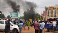 A general view of billowing smoke as supporters of the Nigerien defence and security forces attack the headquarters of the Nigerien Party for Democracy and Socialism (PNDS), the party of overthrown President Mohamed Bazoum, in Niamey on July 27, 2023. (Photo by AFP)

