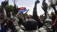 Protesters cheer Nigerien troops as they gather in front of the French Embassy in Niamey during a demonstration that followed a rally in support of Niger's junta in Niamey on July 30, 2023. (Photo by AFP)