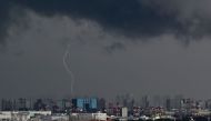 Lightning strikes a building near Tokyo's Haneda Airport (bottom) on August 1, 2023. Photo by Kazuhiro NOGI / AFP