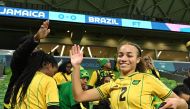 Jamaica's midfielder #02 Solai Washington celebrates her team qualifying for the last 16 following the Australia and New Zealand 2023 Women's World Cup Group F football match between Jamaica and Brazil at Melbourne Rectangular Stadium, also known as AAMI Park, in Melbourne on August 2, 2023. (Photo by WILLIAM WEST / AFP)
