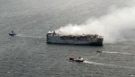 This handout photograph taken on July 29, 2023 and released on July 30, 2023 by the Dutch coastguards, shows smoke rising from the Panamanian-registered car carrier ship Fremantle Highway. Photo by Handout / Netherlands Coastguards / AFP