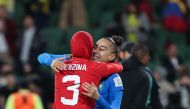 Morocco's defender #03 Nouhaila Benzina (L) embraces Morocco's goalkeeper #22 Ines Arouaissa as they celebrate their team's qualification to the knockout stage after the end of the Australia and New Zealand 2023 Women's World Cup Group H football match between Morocco and Colombia at Perth Rectangular Stadium in Perth on August 3, 2023. (Photo by Colin MURTY / AFP)