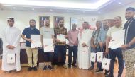 The award winners of the Al Jumailiyah Chess Championship pose for a photograph with officials.