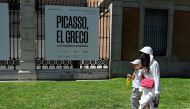 Tourists walk outside the Museo Del Prado in Madrid, on August 6, 2023 as the country is bracing for the third heatwave of the summer. (Photo by Oscar Del Pozo / AFP)