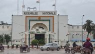 Motorists drive past the National Assembly in Niamey on August 7, 2023. (Photo by AFP)