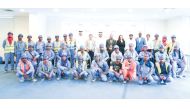 NHRC Secretary-General H E Sultan bin Hassan Al Jamali with workers during the seminar.