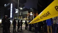 Policemen stand guard outside the hospital where presidential candidate Fernando Villavicencio was taken after being shot at a rally in Quito, on August 9, 2023. (Photo by Galo Paguay / AFP)
