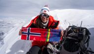 In this handout picture taken on April 26, 2023 by courtesy of Field Productions shows Norwegian climber Kristin Harila with her country flag at Shishapangma, 14th-highest mountain in the world, located in China. Photo by Handout / AFP