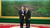 This handout photo taken and released by Cambodia's Government Cabinet on August 13, 2023 shows Cambodia's prime minister-designate Hun Manet (R) shaking hands with China's Foreign Minister Wang Yi at the Peace Palace in Phnom Penh. (Photo by Kok KY / CAMBODIA'S GOVERNMENT CABINET / AFP)
