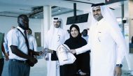 Al Abdulghani Motors representatives and officials distributing water bottles and heat stress awareness materials among drivers and workers.  