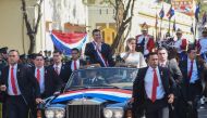 Paraguay's new President Santiago Pena and his wife First Lady Leticia Ocampos wave at supporters after being sworn in, in Asuncion on August 15, 2023. (Photo by Daniel Duarte / AFP)