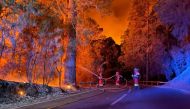 In this handout image released by Military Emergency Unit (UME), military firefighters battle a forest fire on August 17, 2023 raging in the northeastern part of the Canary island of Tenerife. (Photo by Handout / UME / AFP)