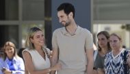 PSG Spanish goalkeeper Sergio Rico with his wife Alba Silva after leaving the hospital in Seville on August 18, 2023. (Photo by Cristina Quicler / AFP)