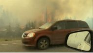 This screengrab from a video provided by Jordan Straker shows vehicles driving on the freeway as people evacuate from Yellowkife, Northwest Territories, Canada, on August 16, 2023. (Photo by Jordan Straker / UGC / AFP)
