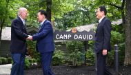 US President Joe Biden (left) welcomes South Korean President Yoon Suk Yeol (centre) and Japanese Prime Minister Fumio Kishida to Camp David, Maryland, for a Trilateral Summit on August 18, 2023. (Photo by Jim Watson / AFP)