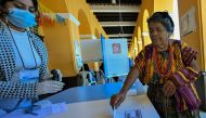 An Indigenous woman casts her vote at a polling station in the municipality of San Juan Sacatepequez, during the Guatemalan presidential run-off election on August 20, 2023. (Photo by Luis Acosta / AFP)
