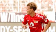 Union Berlin's German forward #17 Kevin Behrens celebrates scoring the 3-0 goal, his hattrick, with his teammates during the German first division Bundesliga football match between 1 FC Union Berlin and 1 FSV Mainz 05 in Berlin on August 20, 2023. (Photo by Odd ANDERSEN / AFP)