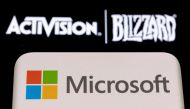 Microsoft logo is seen on a smartphone placed on displayed Activision Blizzard logo in this illustration taken January 18, 2022. File Photo / Reuters

