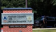 A Fulton County Sheriff officer stands at an entrance to the Fulton County Jail on August 22, 2023 in Atlanta, Georgia. Joe Raedle/Getty Images/AFP 
