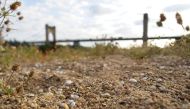 Langeais' bridge is seen from the sand banks of the drought Loire river, central France, on August 22, 2023. (Photo by Guillaume Souvant / AFP)
