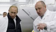 File photo: Businessman Yevgeny Prigozhin (right) points as he shows Russian Prime Minister Vladimir Putin his school lunch factory outside Saint Petersburg on September 20, 2010. (Photo by Alexey Druzhinin / SPUTNIK / AFP)