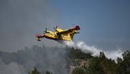 A picture taken on August 24, 2023 shows a Canadair amphibious aircraft, droping water over wildfires spreading in Dadia forest near Alexandroupoli, north Greece, on August 24, 2023. Photo by Sakis MITROLIDIS / AFP