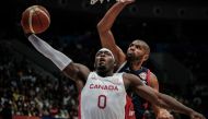 Canada's Luguentz Dort (left) scores as France's Nicolas Batum tries to block during the opening ceremony before the FIBA Basketball World Cup group H match between Canada and France at Indonesia Arena in Jakarta on August 25, 2023. (Photo by Yasuyoshi Chiba / AFP)