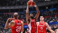 Canada’s Kyle Alexander (C) catches a ball next to Phil Srubb (#22) and Zach Edey (#15) during the FIBA Basketball World Cup group H between Canada and Lebanon at Indonesia Arena in Jakarta on August 27, 2023. Photo by ADEK BERRY / AFP