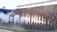 Pyrotechnics go off as Red Bull Racing's Dutch driver Max Verstappen crosses the finish line to win the Dutch Formula One Grand Prix race at The Circuit Zandvoort, in Zandvoort on August 27, 2023. (Photo by JOHN THYS / AFP)