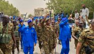 A handout image posted on the Sudanese Armed Forces's facebook page on August 31, 2023, shows army chief General Abdel Fattah al-Burhan (C) gesturing as he walks among other army members during a tour of a neighbourhood in Port Sudan, in the Red Sea state. (Photo by Sudanese Army / AFP)