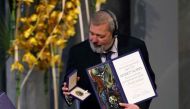 Nobel Peace Prize laureate Dmitry Muratov of Russia poses with the Nobel Peace Prize diploma and medal during the gala award ceremony for the Nobel Peace prize on December 10, 2021 in Oslo. (Photo by Odd ANDERSEN / AFP)
