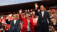 File photo: Thai candidates for prime minister Paetongtarn Shinawatra (C), Srettha Thavisin (R) and Chaikasem Nitisiri (L) wave to the crowd during an election rally for Thailand's main opposition Pheu Thai party at the Thunder Dome Stadium in Nonthaburi, north of the capital Bangkok, on April 5, 2023. (Photo by Jack Taylor / AFP)

