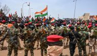 Nigerien soldiers stand guard as supporters of Niger's National Council of Safeguard of the Homeland (CNSP) protest outside the Niger and French airbase in Niamey on September 2, 2023 to demand the departure of the French army from Niger. (Photo by AFP)
