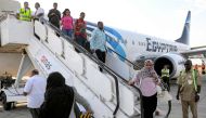 Passengers disembark off an EgyptAir Boeing 737 aircraft upon landing for the first time at Port Sudan International Airport on September 5, 2023 upon the inauguration of a new international flight route between Cairo and Port Sudan. (Photo by AFP)