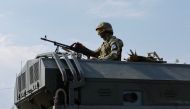 A Russian service member holds a weapon on the top of a military vehicle in the course of Ukraine-Russia conflict in the Russian-controlled city of Enerhodar in the Zaporizhzhia region, Ukraine, September 1, 2022. (REUTERS/Alexander Ermochenko)