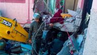Rescue workers search for survivors in a collapsed house in Moulay Brahim, Al Haouz province, on September 9, 2023. (Photo by Fadel SENNA / AFP)