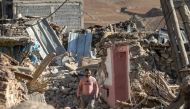 A man walks past destroyed houses after an earthquake in the mountain village of Tafeghaghte, southwest of the city of Marrakesh, on September 9, 2023. Photo by FADEL SENNA / AFP