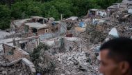 A man looks at the rubble of homes in the mountain village of Imi N'Tala, south of Marrakech, on September 10, 2023.  (Photo by Matias Chiofalo / AFP)
