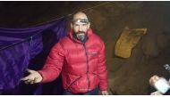 (Files) This video grab taken from footage released by The Turkish Direction of Communication on September 8, 2023, shows US caver Mark Dickey as he speaks to the camera while standing at a camp in the Morca Cave of the Taurus Mountains in southern Turkey. (Photo by Handout/ Turkish Direction of Communication / AFP) /