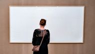 A woman stands in front of an empty frame hung up at the Kunsten Museum in Aalborg, Denmark, on September 28, 2021. (Photo by Henning Bagger / Ritzau Scanpix / AFP)