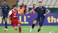 Al Nassr’s Cristiano Ronaldo (right) and Persepolis’ Mohammad Omri vie for the ball. AFP