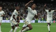 Real Madrid's English midfielder #5 Jude Bellingham celebrates with teammates scoring his team's first goal during the UEFA Champions League 1st round day 1 group C football match between Real Madrid and Union Berlin at the Santiago Bernabeu stadium in Madrid on September 20, 2023. (Photo by Thomas COEX / AFP)
