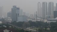 The Manila skyline is seen shrouded in smog on September 22, 2023. (Photo by JAM STA ROSA / AFP)
