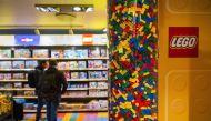 This file photo taken on November 29, 2022 shows people checking LEGO boxes at a shop in the hotel LEGOLAND in Billund, Denmark. Photo by Jonathan NACKSTRAND / AFP