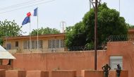 (Files) Officers of the Niger national Police are seen outside the French Embassy in Niamey on August 28, 2023. (Photo by AFP)
 