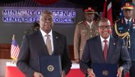US Defence Secretary, Lloyd's Austin (left) poses alongside Kenya's Cabinet secretary for Defence, Aden Duale with copies of the Defence Coocperation Agreements they signed at a joint press conference at the Defence Headquarter's in Nairobi on September 26, 2023. (Photo by Tony Karumba / AFP)