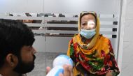 A doctor examines a patient suffering from an eye infection at a hospital in Lahore on September 27, 2023. (Photo by Arif Ali / AFP)