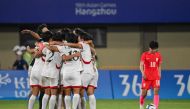 North Korea's players (L) celebrate after winning the women's football quarter-final match against South Korea during the Hangzhou 2022 Asian Games in Wenzhou, China's eastern Zhejiang province on September 30, 2023. (Photo by Hector RETAMAL / AFP)

