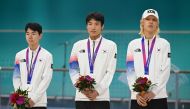 Silver medallists South Korea's Jung Cheol-won, Choi In-ho and Choi Gwang-ho attend the awards ceremony of the men's 3000m relay speed skating event during the 2022 Asian Games in Hangzhou in China's eastern Zhejiang province on Octorber 2, 2023. (Photo by WANG Zhao / AFP)