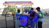 A vendor exhibits t-shirts to customers outside the Narendra Modi Stadium, ahead of the 2023 ICC men's cricket World Cup, in Ahmedabad on October 2, 2023.  (Photo by Sam Panthaky / AFP)
 